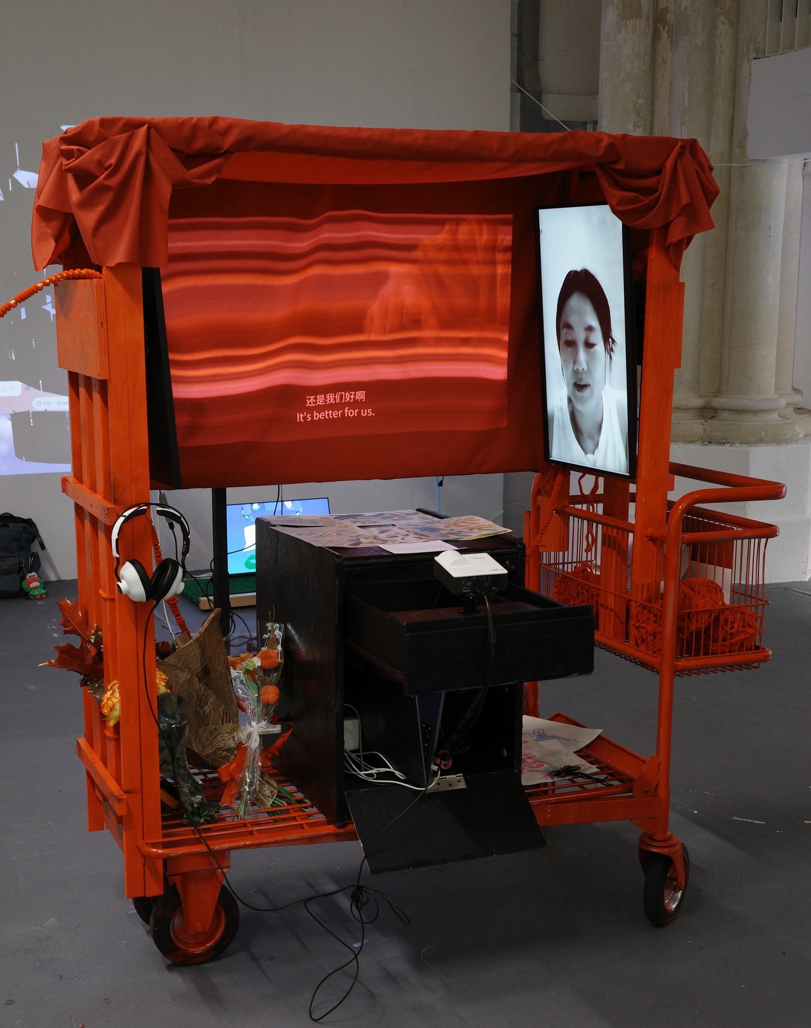 Overhead view of the red pushable cart installation with screens and surrounding objects