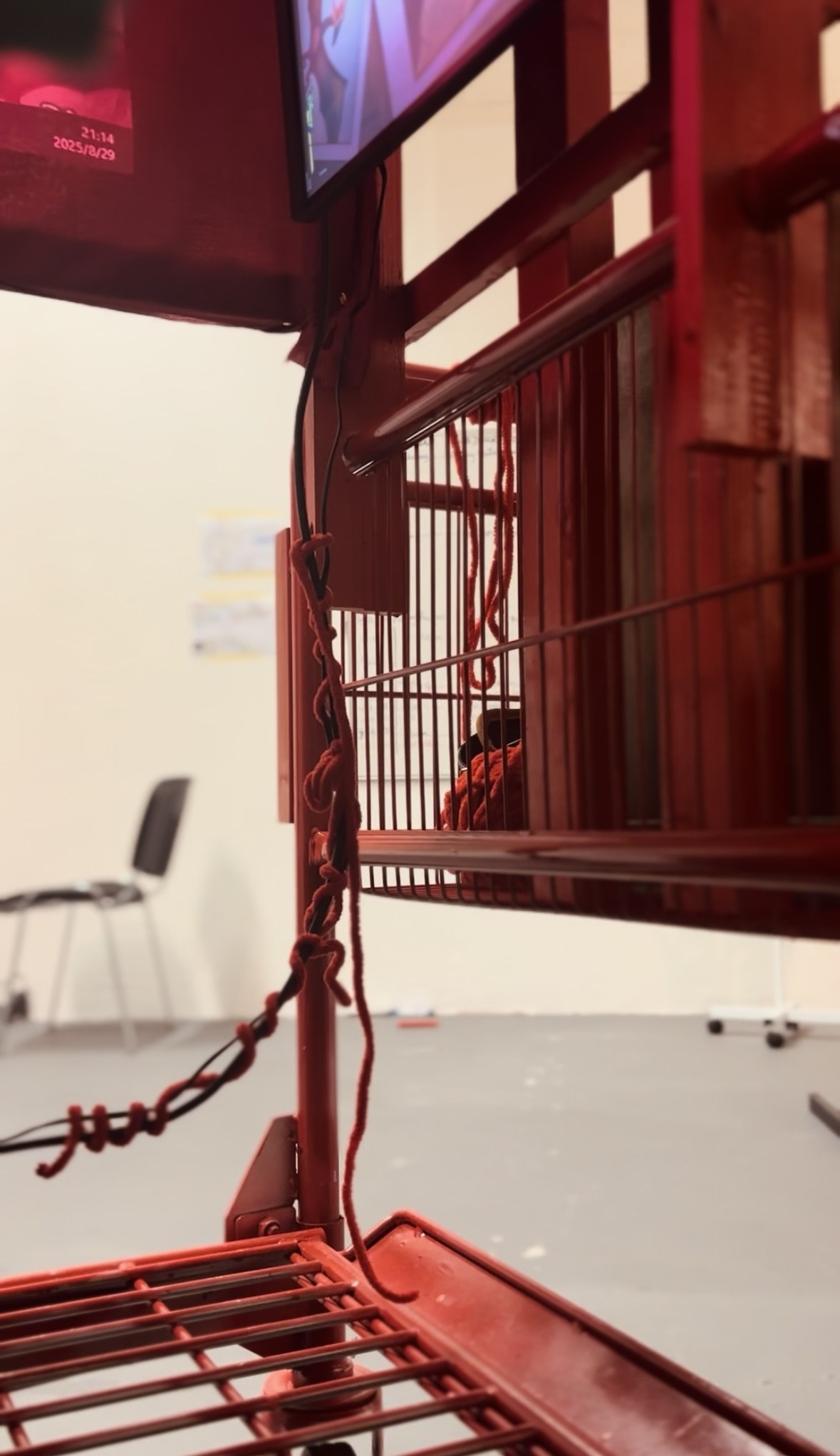 Red cart and object detail within the installation